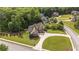An aerial view of the neighborhood and the home's mature landscaping and expansive yard surrounded by verdant trees at 9742 Fallview Ct, Villa Rica, GA 30180