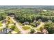 An aerial view of a neighborhood surrounded by lush greenery and mature trees at 9742 Fallview Ct, Villa Rica, GA 30180