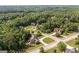 Wide aerial shot showcasing a home in a community surrounded by lush, green trees at 9742 Fallview Ct, Villa Rica, GA 30180