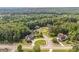 Aerial view of a home nestled in a lush, green, wooded neighborhood, with mature trees at 9742 Fallview Ct, Villa Rica, GA 30180