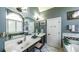 This bathroom has double sinks, large mirrors, and tile floors in a well-lit space at 9742 Fallview Ct, Villa Rica, GA 30180