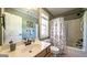 This renovated bathroom features a single sink vanity and a full tub and shower with modern fixtures at 9742 Fallview Ct, Villa Rica, GA 30180