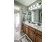 This bathroom features a double sink vanity with plentiful storage space and a shower with glass door at 9742 Fallview Ct, Villa Rica, GA 30180