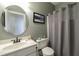 This bathroom features a granite countertop, framed mirror and tiled shower at 9742 Fallview Ct, Villa Rica, GA 30180