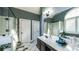 Well-lit bathroom with tile floors, glass shower, and and sinks at 9742 Fallview Ct, Villa Rica, GA 30180