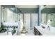 Bright bathroom with tile floors, glass shower, and soaking tub at 9742 Fallview Ct, Villa Rica, GA 30180