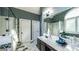 A light and bright bathroom with double sinks, a framed mirror, and white cabinets at 9742 Fallview Ct, Villa Rica, GA 30180