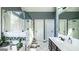 Bathroom with double sinks, mirrors, and white cabinets at 9742 Fallview Ct, Villa Rica, GA 30180
