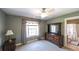 Neutral bedroom with a bathroom entrance that offers a serene space with a large window for natural lighting at 9742 Fallview Ct, Villa Rica, GA 30180