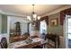 Traditional dining room featuring hardwood floors, a chandelier, and decorative molding at 9742 Fallview Ct, Villa Rica, GA 30180