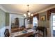 Formal dining room features hardwood floors, elegant wainscoting, and decorative chandelier at 9742 Fallview Ct, Villa Rica, GA 30180