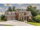 Charming two-story home with manicured lawn, mature trees, and attached two-car garage at 9742 Fallview Ct, Villa Rica, GA 30180
