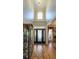 The spacious foyer features hardwood floors, a soaring ceiling, and a beautiful front door with glass panels at 9742 Fallview Ct, Villa Rica, GA 30180