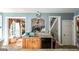 Kitchen with oak cabinets, granite countertops, a refrigerator, and a doorway to the dining and living area at 9742 Fallview Ct, Villa Rica, GA 30180
