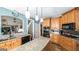 Open concept kitchen features granite countertops, oak cabinets and stainless steel appliances and a center island at 9742 Fallview Ct, Villa Rica, GA 30180