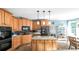 Eat-in kitchen features custom cabinets, granite countertops, tile flooring, and stainless steel appliances at 9742 Fallview Ct, Villa Rica, GA 30180