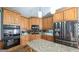 Spacious kitchen featuring wood cabinets, stainless steel appliances, granite countertops, and center island at 9742 Fallview Ct, Villa Rica, GA 30180
