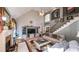 Bright living room with a cozy fireplace, vaulted ceiling, and staircase to the upper level at 9742 Fallview Ct, Villa Rica, GA 30180