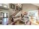 Bright living room features a fireplace, vaulted ceiling, and an open staircase, enhancing the home's spaciousness at 9742 Fallview Ct, Villa Rica, GA 30180