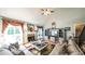 Bright living room with fireplace, vaulted ceiling, and staircase to the upper level at 9742 Fallview Ct, Villa Rica, GA 30180
