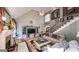 Bright living room features a fireplace, vaulted ceiling, and an open staircase, enhancing the home's spaciousness at 9742 Fallview Ct, Villa Rica, GA 30180