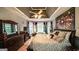 Spacious primary bedroom featuring a tray ceiling, dark wood floors, and a large bed at 9742 Fallview Ct, Villa Rica, GA 30180
