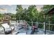 Outdoor deck featuring comfortable seating for entertaining with views of surrounding greenery at 9742 Fallview Ct, Villa Rica, GA 30180