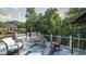 A spacious outdoor deck features comfortable seating, a black metal railing, and views of the home's beautiful yard at 9742 Fallview Ct, Villa Rica, GA 30180