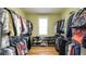Spacious walk-in closet with plenty of hanging and storage space for shoes and handbags at 9742 Fallview Ct, Villa Rica, GA 30180