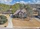 Aerial view of a two-story brick home with manicured landscaping and long driveway at 101 Lumby Ln, Stockbridge, GA 30281