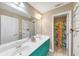 Bright bathroom with double sinks, a large mirror, and colorful shower curtain at 101 Lumby Ln, Stockbridge, GA 30281