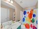 Bathroom with single sink, shower and tub combo, toilet, and large mirror at 101 Lumby Ln, Stockbridge, GA 30281