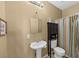 Cozy bathroom features a pedestal sink, decorative mirror, and cabinet above the toilet at 101 Lumby Ln, Stockbridge, GA 30281