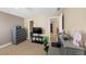 Bedroom with neutral walls, TV, desk, and gray dresser at 101 Lumby Ln, Stockbridge, GA 30281