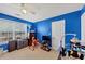 Bedroom with blue walls, carpet, and natural light at 101 Lumby Ln, Stockbridge, GA 30281