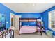 Bedroom with blue walls and bunk beds at 101 Lumby Ln, Stockbridge, GA 30281