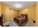 Cozy bedroom with a brown and black patterned bedspread and neutral colored walls and carpet at 101 Lumby Ln, Stockbridge, GA 30281