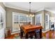 Inviting dining area features a chandelier, large windows, and hardwood floors for an enjoyable experience at 101 Lumby Ln, Stockbridge, GA 30281