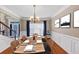Charming dining area featuring a chandelier and set table adjacent to the staircase at 101 Lumby Ln, Stockbridge, GA 30281