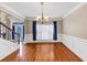 Spacious dining room with hardwood floors, detailed trim, and a decorative chandelier at 101 Lumby Ln, Stockbridge, GA 30281