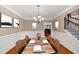 Elegant dining room featuring a chandelier and a set table adjacent to the staircase at 101 Lumby Ln, Stockbridge, GA 30281