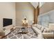 Bright living room with hardwood floors, tall ceilings, and modern decor at 101 Lumby Ln, Stockbridge, GA 30281