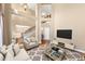 Open-concept living room with hardwood floors, staircase, and modern decor at 101 Lumby Ln, Stockbridge, GA 30281