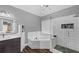 Stylish bathroom featuring a modern vanity, soaking tub, and glass-enclosed shower with unique tiling at 101 Lumby Ln, Stockbridge, GA 30281