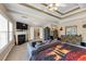 Spacious main bedroom featuring tray ceilings, fireplace, sitting area, and ensuite bathroom access at 101 Lumby Ln, Stockbridge, GA 30281