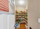Walk-in pantry featuring wood floor and multiple shelves stocked with an assortment of food items and containers at 101 Lumby Ln, Stockbridge, GA 30281
