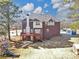 The brick home features a back deck and a large yard with a playset at 101 Lumby Ln, Stockbridge, GA 30281