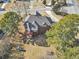 A lovely view of the back of the home with a large yard, mature trees and a deck at 101 Lumby Ln, Stockbridge, GA 30281