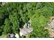 Secluded estate surrounded by mature trees featuring a large home, pool, and lush landscaping offering privacy at 1023 Little Darby Ln, Suwanee, GA 30024