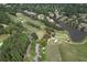 Elevated view of golf course and lake surrounded by trees and luxury homes at 1023 Little Darby Ln, Suwanee, GA 30024